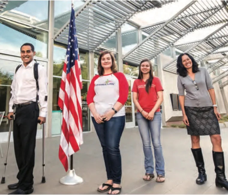 people standing next to a flag